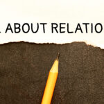 Close up on businessman holding a wooden block with Building Solid Relations For Lasting Success message